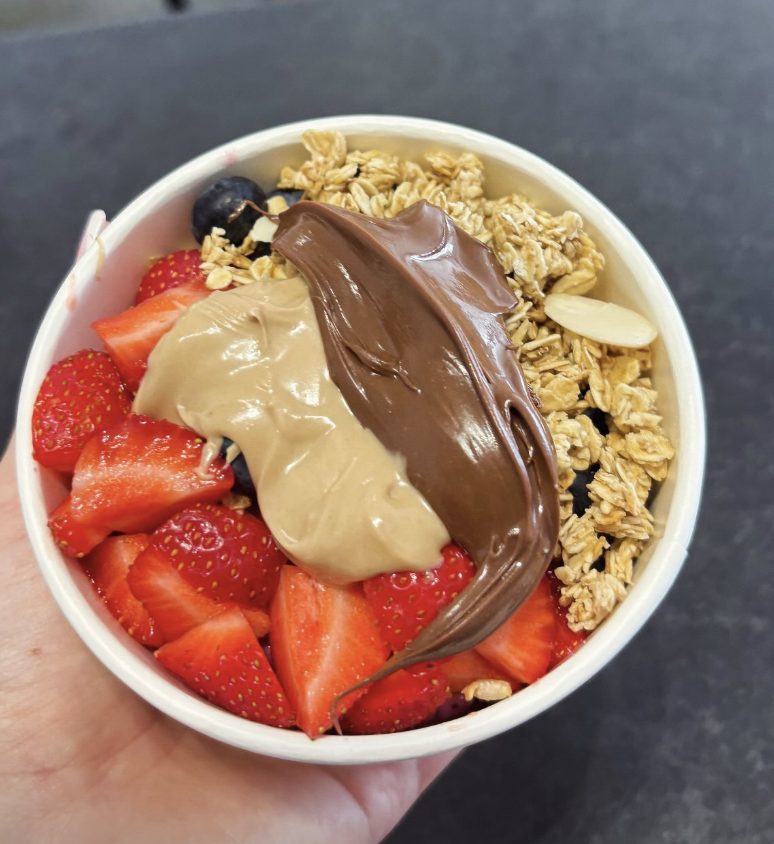 Açaí bowl with strawberries, granola and nut butter
