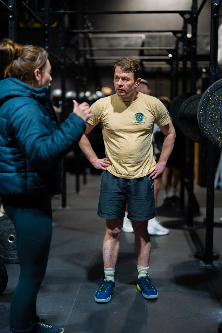 Coach talking a member through a lift
