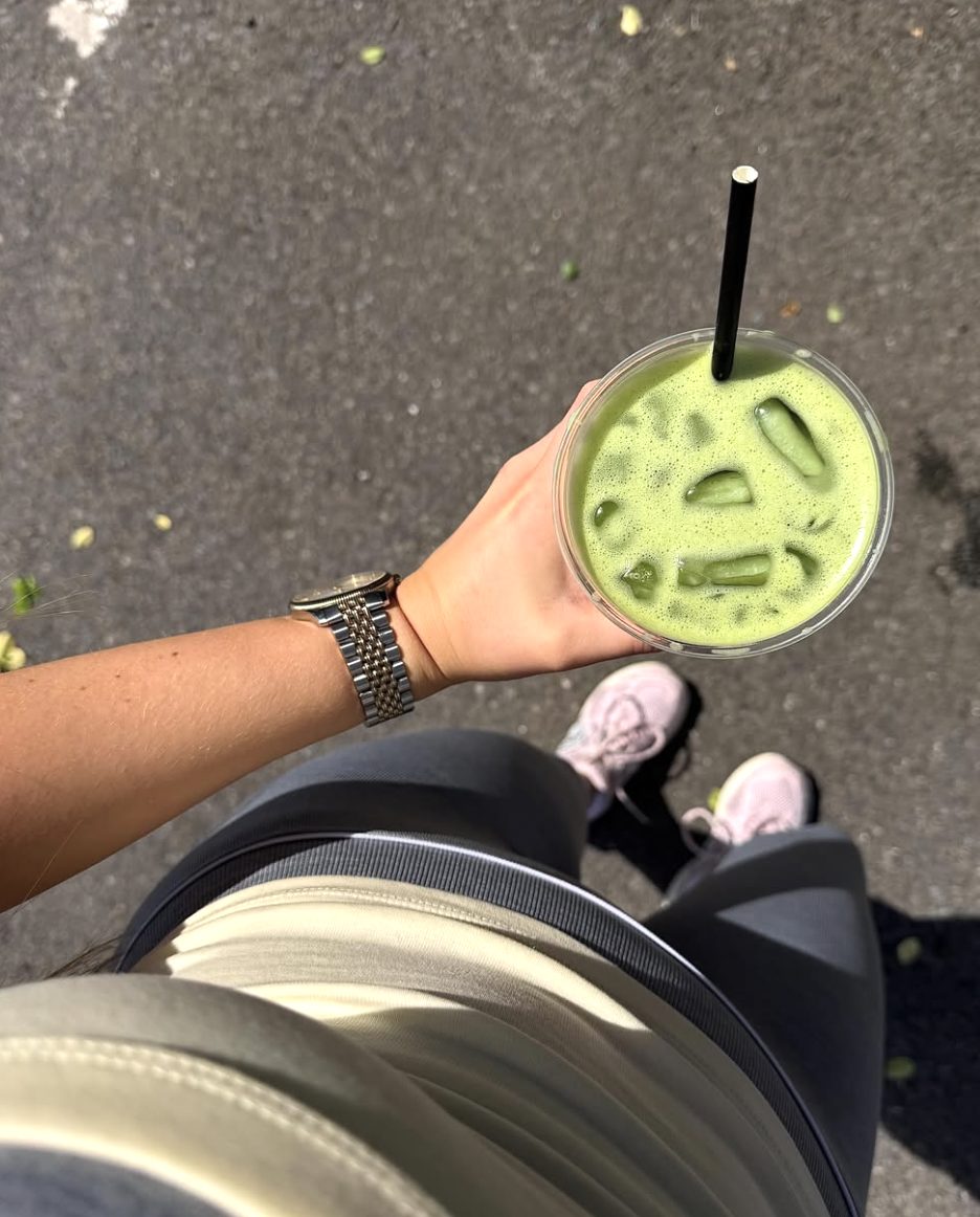 Iced matcha held over the pavement