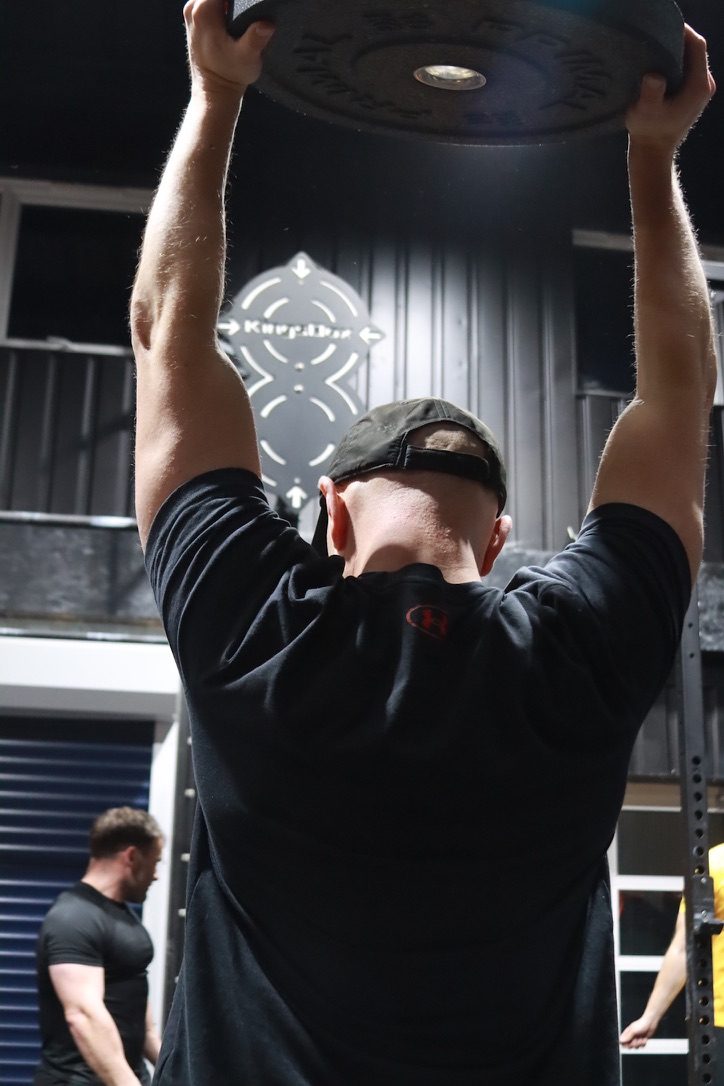 Member pressing a plate overhead