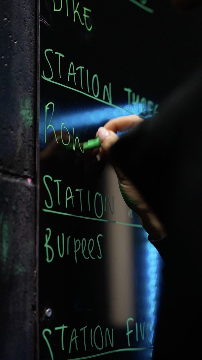 Coach writing up the session on the whiteboard